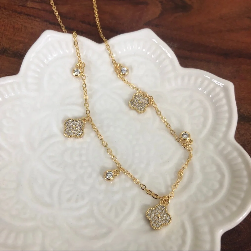 gold dangle station necklace encrusted clover charm round bezel set Cubic Zircon
